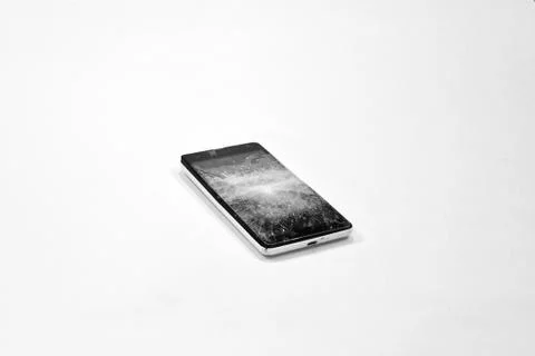 Cell phone with the screen broken by a hammer. Stock Photos