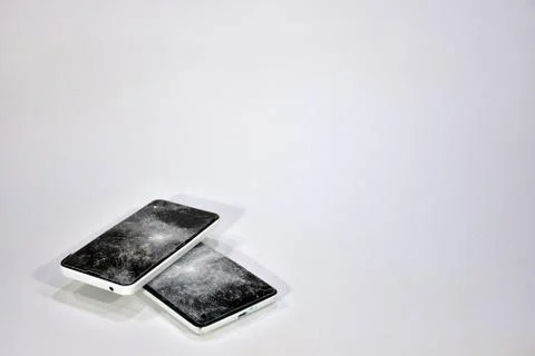 Cell phone with the screen broken by a hammer. Stock Photos