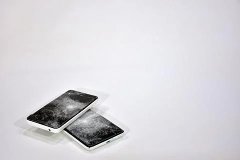 Cell phone with the screen broken by a hammer. Stock Photos