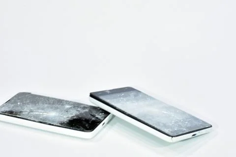 Cell phone with the screen broken by a hammer. Stock Photos