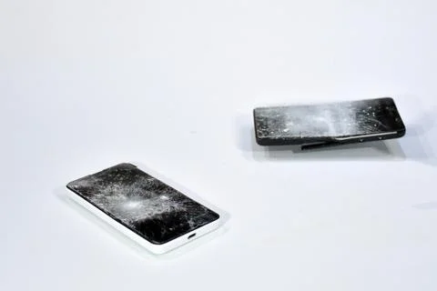 Cell phone with the screen broken by a hammer. Stock Photos