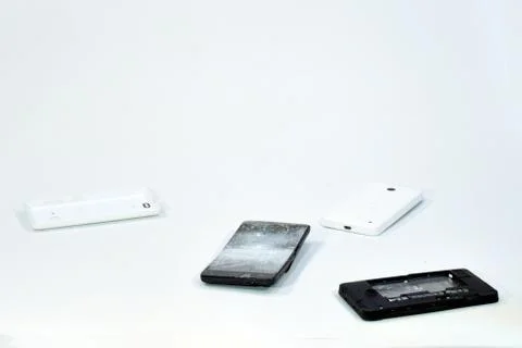 Cell phone with the screen broken by a hammer. Stock Photos