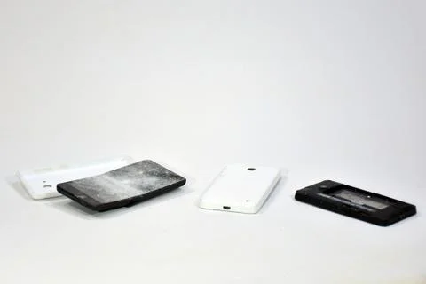 Cell phone with the screen broken by a hammer. Stock Photos