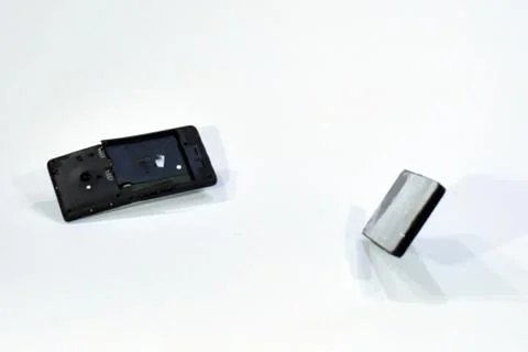 Cell phone with the screen broken by a hammer. Stock Photos