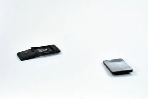 Cell phone with the screen broken by a hammer. Stock Photos