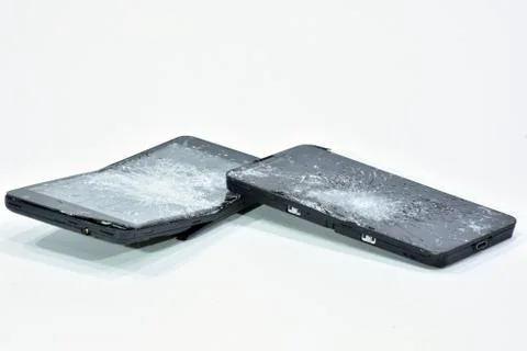 Cell phone with the screen broken by a hammer. Stock Photos