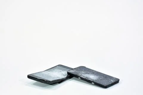 Cell phone with the screen broken by a hammer. Stock Photos