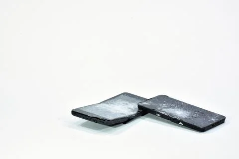 Cell phone with the screen broken by a hammer. Stock Photos