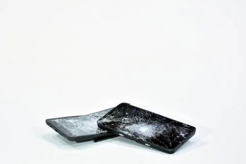 Cell phone with the screen broken by a hammer. Stock Photos