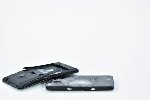 Cell phone with the screen broken by a hammer. Stock Photos