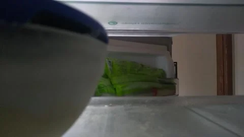 Cell Phone shot from a man taking out packages from his freezer in southeast bra Vídeo Stock 218641503