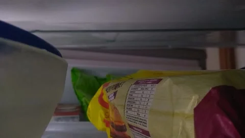 Cell Phone shot from a man taking out packages from his freezer in southeast bra Video stock 218641509