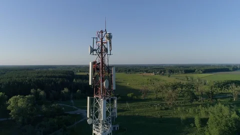 Cell phone telecommunication tower, drone view of worker servicing antenna Stock Footage