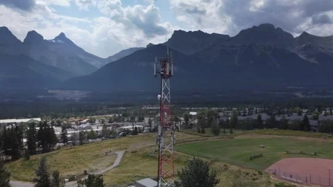 Cell Phone Tower in Mountain Town, wide circling, aerial, drone 스톡 동영상 344087326
