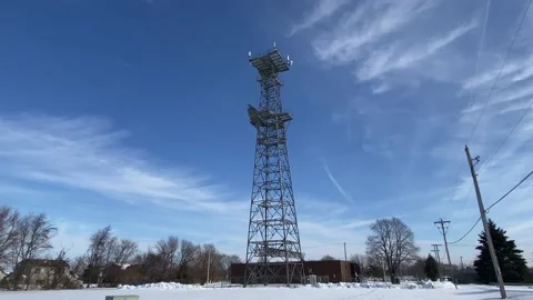 Cell Phone Tower / Telecommunications Tower - Blue Sky Stock Footage 168714874