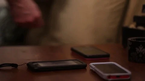 Cell Phones are Set on an End Table Stock Footage 77010099