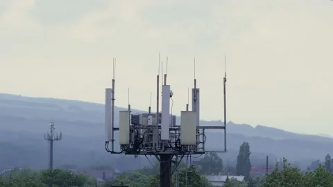 Cell tower 3G 4G 5G in the city in windy weather. concept of bad cellular Stock Footage 131338912