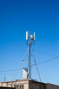 Cell tower against clear blue sky Stock Photos