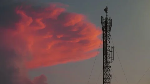 Cell tower and big red sunset cloud Video stock 156801289