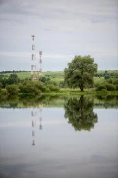 Cell tower and reflections in large ponds. Stock Photos