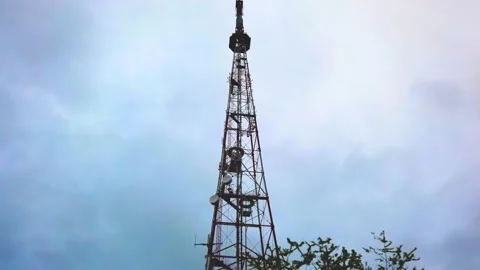 Cell tower on the background of a cloudy sky Stock Footage 154503393