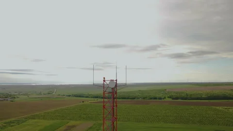 Cell tower on the background of green hills and sky. Telecommunications and Stock Footage 278153210