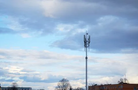 Cell tower on the background of the sky and clouds in the evening Stock Photos