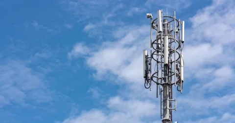 Cell tower on blue sky background. Floating clouds in blue sky, time lapse. Stock Footage 131314116