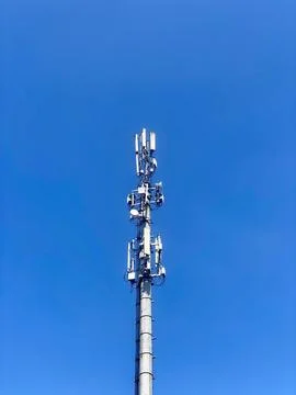 Cell tower, blue sky background. 3g, 4g, 5g. Mobile communications, various data Stock Photos