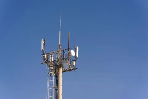 The cell tower operator on the blue sky Stock Photos
