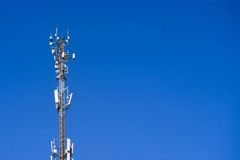 The cell tower operator on the blue sky Stock Photos