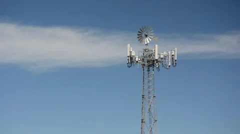 Cell tower poorly disguised as an antique farm wind mill Stock Footage 60664626