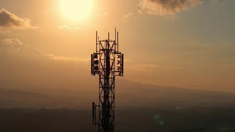 Cell tower silhouette against vibrant sunset sky and clouds. Stock Footage 340323630