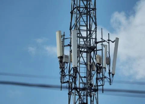 Cell tower with sky background and blur wire frontground Stock Photos