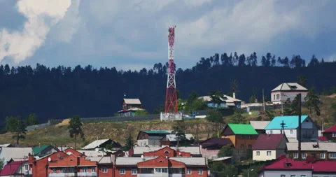 Cell tower standing on a hill among residential houses in a rural area Stock Footage 302565892