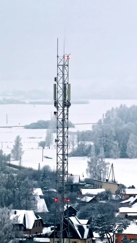 Cell tower structure with blinking red warning lights against cold winter s.. Stock Footage 337783484