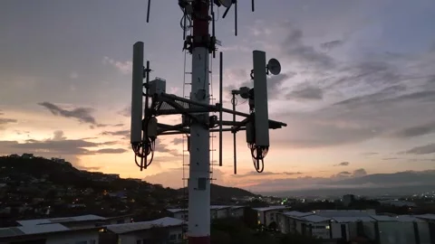 Cell Tower With Wireless Antennas Silhouetted Against Sky (Close-Up Drone Video) 스톡 동영상 237380196