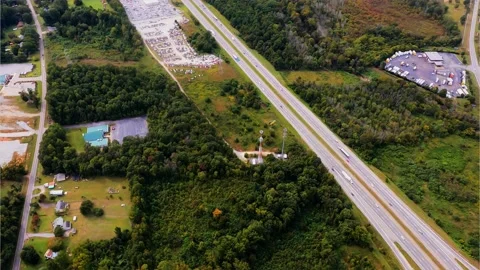 Cell Towers Alongside Interstate and Large Car Auction Facility Stock Footage 140473804