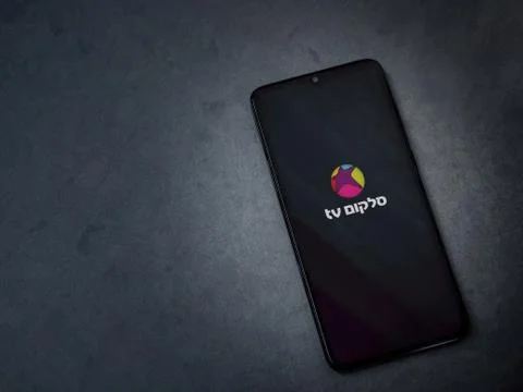 Cellcom TV app launch screen with logo on the display of a black mobile smart Stock Photos