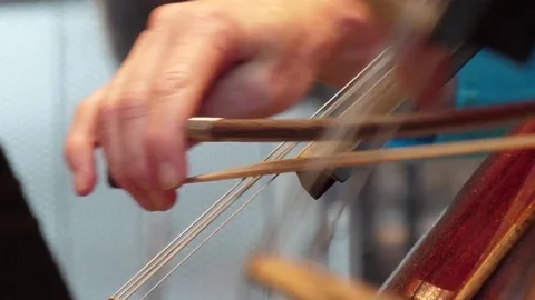 Cellist playing cello in orchestra Stock Footage