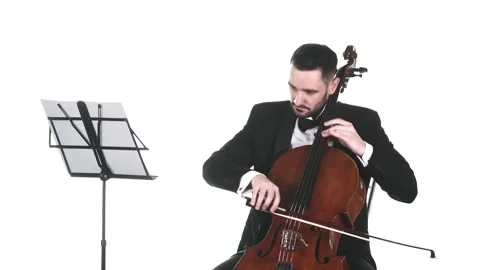 Cellist in a tuxedo performs a slow melody. Medium long shot. Isolated Stock Footage 134494765