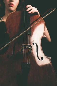 Cello and Bow Instrument Hold by a Female Musician Stock Photos