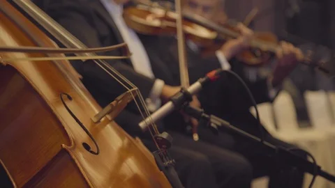 Cello in the foreground and a classical background orchestra harmonizing Video stock 126189671