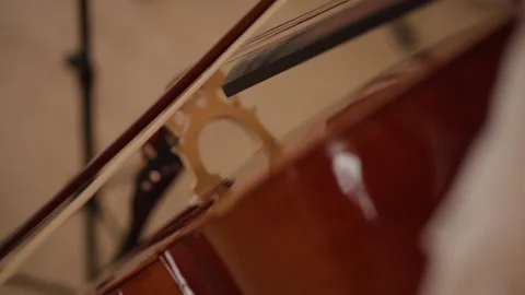 Cello musical instrument and bow closeup. Person hand play in orchestra Stock Footage