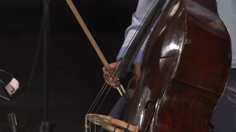 Cello musican playing single note long smooth bow movement hand flourish Stock Footage 139020238