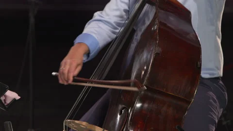 Cello orchestra musician using bow to stab out bass rhythm music notes Stock Footage 139020400