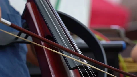 Cello player playing cello bow outdoor, Close up of Man hand playing cello. Stock Footage 214209573