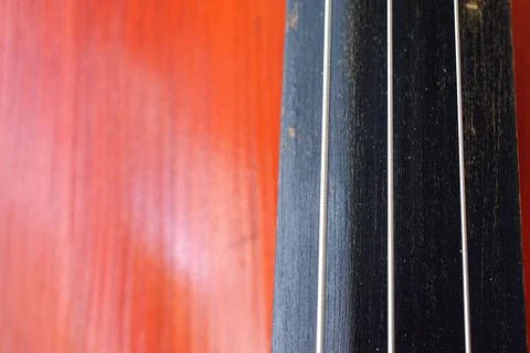 Cello strings and fingerboard. Old brown cello. Foto stock