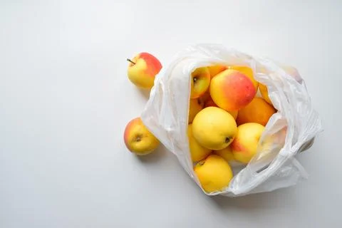 A cellophane bag with fresh apples Stock Photos