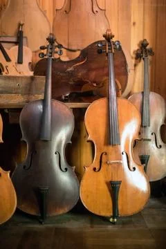 Cellos standing in luthier workshop Stock Photos